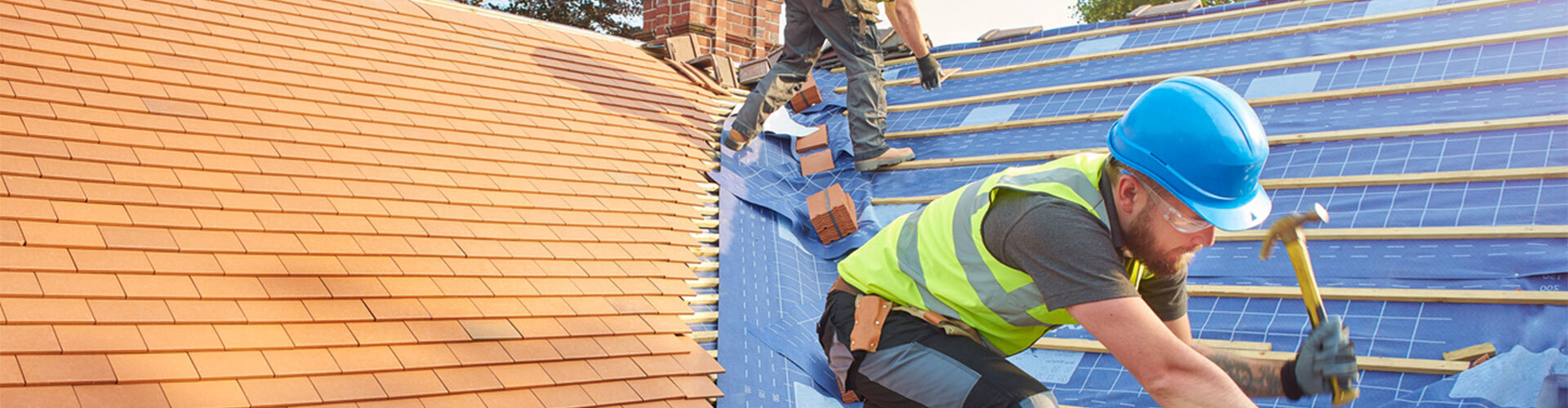 MJ Design & Building roofer laying tiles on site